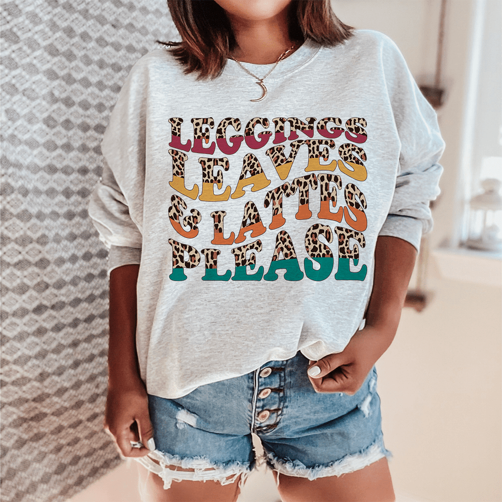 Person wearing a sweatshirt with colorful text and leopard print accents.